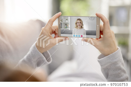 Video call with daughter using smartphone 97010753