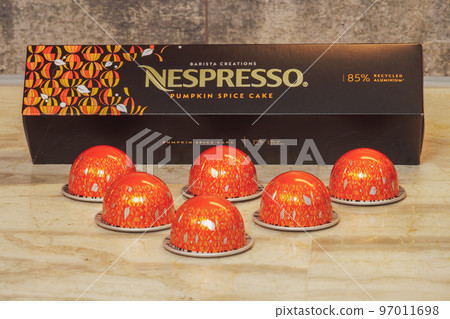 Nespresso Vertuo Pop machine pumpkin spice cake aluminum pods with box and logo, used to create espresso-dripping coffee. 97011698