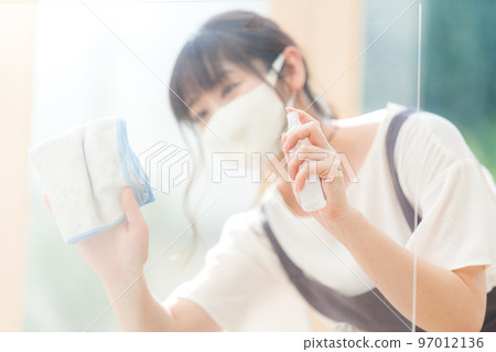 A female clerk at a cafe disinfecting an acrylic board A female clerk at a cafe disinfecting an acrylic board 97012136