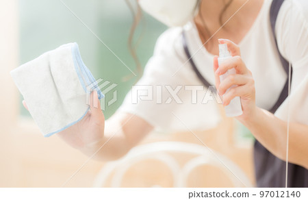 A female clerk at a cafe disinfecting an acrylic board A female clerk at a cafe disinfecting an acrylic board 97012140