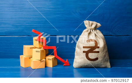 Ukrainian hryvnia money bag with boxes and down arrow. Income decrease, decline of economy. Low sales. Production decline. Reduced transportation prices. Bad consumer sentiment and demand for goods. 97012917