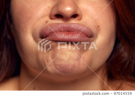 Close-up view of female perfect shape mouth with nude colored lipstick and chin. Grimace, Anti-wrinkles cosmetological care, face fillers 97014559
