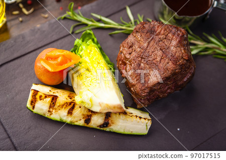 Black Angus Chateaubriant steak. Tenderloin from Brazil. Delicious healthy traditional food closeup served for lunch in modern gourmet cuisine restaurant Black Angus Chateaubriant steak. Tenderloin from Brazil. Delicious healthy traditional food closeup served for lunch in modern gourmet cuisine restaurant 97017515