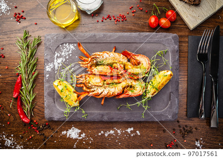 Lobster with flavored butter. Herb butter, lemon. Delicious healthy traditional food closeup served for lunch in modern gourmet cuisine restaurant 97017561
