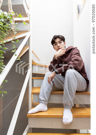Men sitting on the stairs 97020080