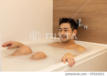 Man to relax in the bath 97020832