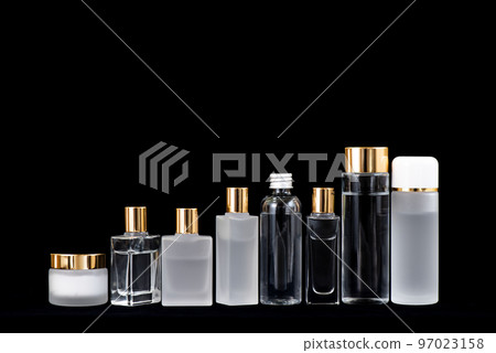 8 cosmetic containers of various types arranged on a black background 97023158