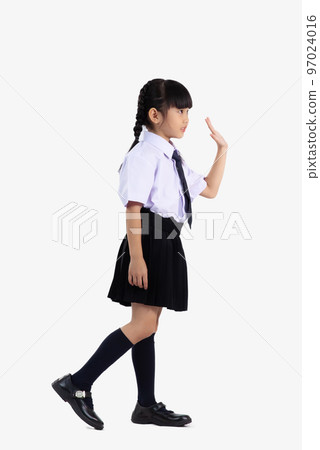 Asian student international school in uniform standing full length waving hand on white background. Asian student international school in uniform standing full length waving hand on white background. 97024016