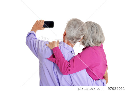 Senior couple taking selfie Senior couple taking selfie 97024031