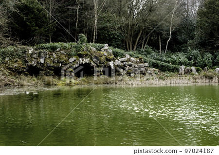 Claremont lake with old bridge - Esher, UK 97024187