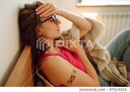 Woman blogger videotapes her vlog at home and speaking about Vaccine for covid-19. 97024816