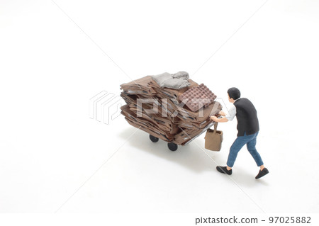 the Elderly scavenger with cardboard on trolley 97025882