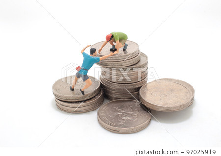 a mini climbers team climbing on stack of coins a mini climbers team climbing on stack of coins 97025919