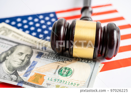 Gavel for judge lawyer and US dollar banknotes on USA America flag, finance concept. Gavel for judge lawyer and US dollar banknotes on USA America flag, finance concept. 97026225