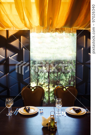 Sparkling glassware stands on long table prepared for wedding dinner. Sparkling glassware stands on long table prepared for wedding dinner. 97026340