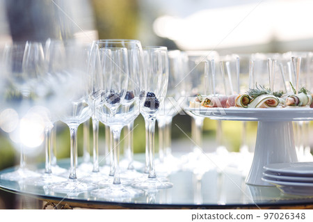 Champagne glasses on gold background. Party and holiday celebration concept 97026348
