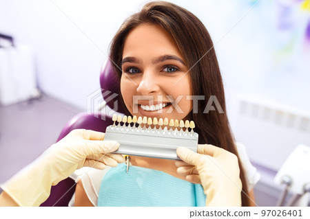 Overview of dental caries prevention. Woman at the dentist's chair during a dental procedure.. Healthy Smile. 97026401