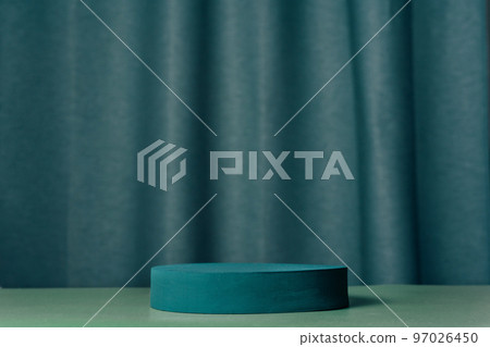 Oval teal podium, pedestal on a blue curtain background Oval teal podium, pedestal on a blue curtain background 97026450