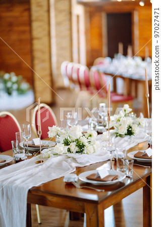 Beautiful table setting for a party, wedding reception or other festive event. Banquet setting, glasses, plates. Beautiful table setting for a party, wedding reception or other festive event. Banquet setting, glasses, plates. 97027471