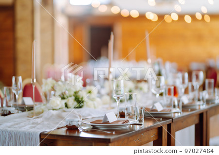 Beautiful table setting for a party, wedding reception or other festive event. Banquet setting, glasses, plates. Beautiful table setting for a party, wedding reception or other festive event. Banquet setting, glasses, plates. 97027484