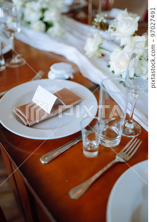 Beautiful table setting for a party, wedding reception or other festive event. Banquet setting, glasses, plates. Beautiful table setting for a party, wedding reception or other festive event. Banquet setting, glasses, plates. 97027491