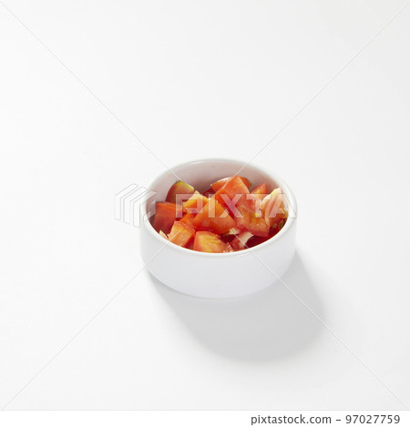 Fresh plum tomato slices, in a bowl, isolated on white. 97027759