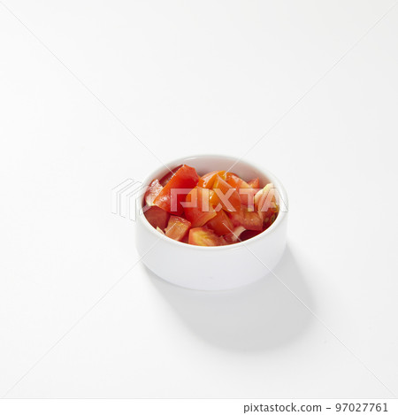 Fresh plum tomato slices, in a bowl, isolated on white. 97027761