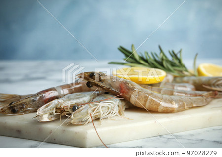 Fresh raw shrimps on marble table, closeup 97028279