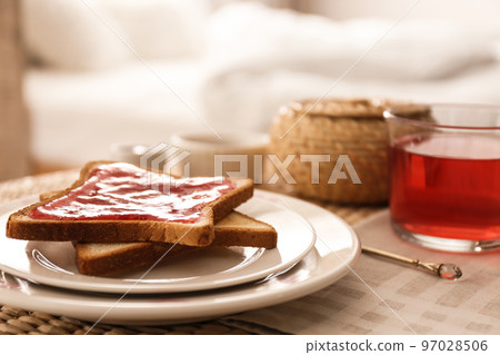 Toasts and tea on table indoors. Delicious morning meal 97028506