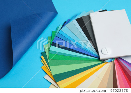 Color palette and bright paper on light blue background Color palette and bright paper on light blue background 97028578