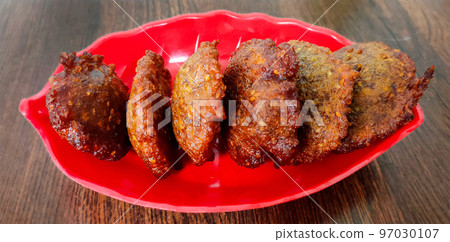 Delicious Indian dish called Gulgula is served in a plate Delicious Indian dish called Gulgula is served in a plate 97030107