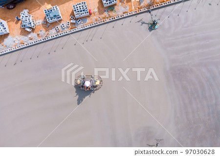 Process polishing and leveling cement screed mortar floors on construction site in process construction 97030628