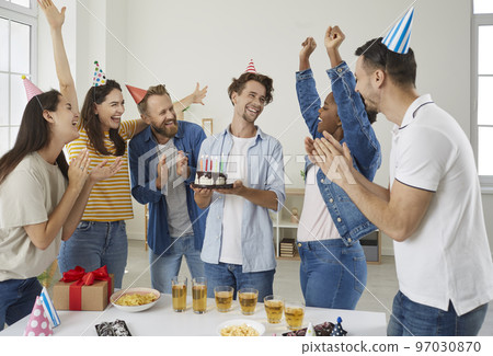 Group of happy, cheerful, excited people having fun at a birthday party of their friend 97030870