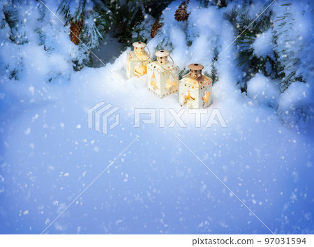 Lanterns in the snow under the Christmas tree Lanterns in the snow under the Christmas tree 97031594