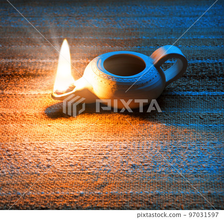 Ancient lamp shines in the dark 97031597