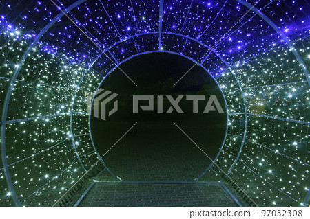 tunnel and illuminations of blue green white on a black dark background. New Year's Eve Christmas. Photoona festive atmosphere 97032308
