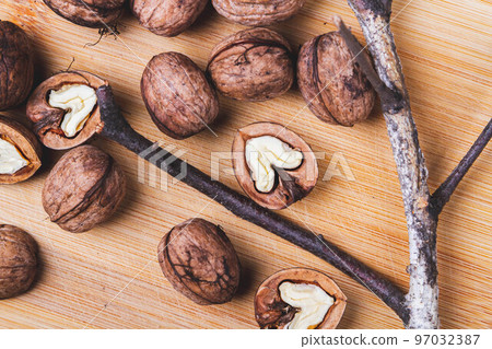 Walnut. Half walnut on natural background. Inshell nuts. Copyspace. 97032387