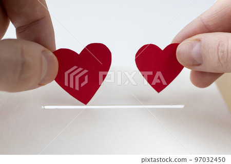 The concept of charity, love, donation and helping hands. A woman and a man hand puts the heart in the donation slot. Donating blood or human organs, saving lives. The concept of charity, love, donation and helping hands. A woman and a man hand puts the heart in the donation slot. Donating blood or human organs, saving lives. 97032450