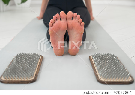 Close-up on the feet of a woman after standing on the nails of a sadhu. Close-up on the feet of a woman after standing on the nails of a sadhu. 97032864
