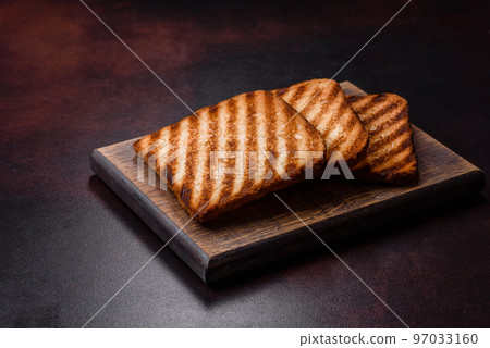 Tasty fresh crispy bread slices in the form of grilled toast Tasty fresh crispy bread slices in the form of grilled toast 97033160