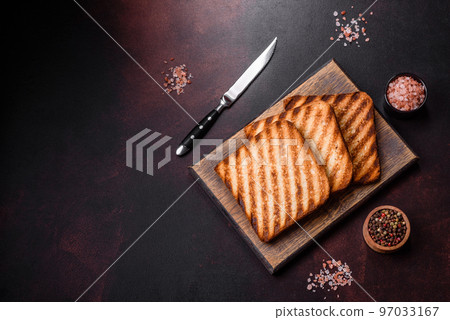 Tasty fresh crispy bread slices in the form of grilled toast Tasty fresh crispy bread slices in the form of grilled toast 97033167