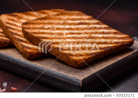 Tasty fresh crispy bread slices in the form of grilled toast Tasty fresh crispy bread slices in the form of grilled toast 97033171