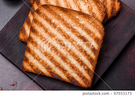 Tasty fresh crispy bread slices in the form of grilled toast Tasty fresh crispy bread slices in the form of grilled toast 97033173