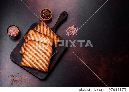 Tasty fresh crispy bread slices in the form of grilled toast Tasty fresh crispy bread slices in the form of grilled toast 97033175