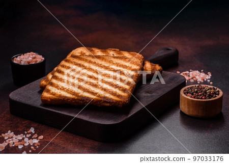 Tasty fresh crispy bread slices in the form of grilled toast Tasty fresh crispy bread slices in the form of grilled toast 97033176