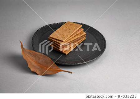 white chocolate pieces stacked over each other on plate. copy space text area 97033223