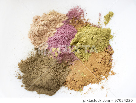 Powder of henna and other herbs for coloring and strengthening hair. Make henna paste at home. Still life with henna. Selective focus. Powder of henna and other herbs for coloring and strengthening hair. Make henna paste at home. Still life with henna. Selective focus. 97034220