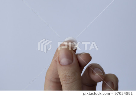 Round pimple patch in a woman's hand on a white background. Pimple Patches for Facial Cleansing Round pimple patch in a woman's hand on a white background. Pimple Patches for Facial Cleansing 97034891