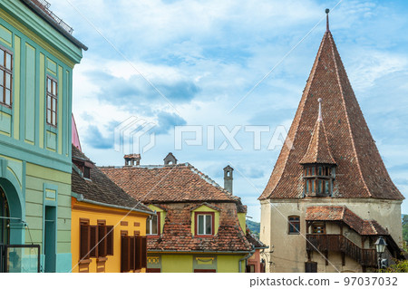 Shoemakers guild tower and colorful romanian houses, Sighisoara, Transylvania, Romania Shoemakers guild tower and colorful romanian houses, Sighisoara, Transylvania, Romania 97037032