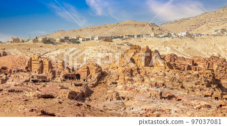 View to the ancient Nabataean Moghar Annasara tombs with Wadi Musa town in the background, Petra View to the ancient Nabataean Moghar Annasara tombs with Wadi Musa town in the background, Petra 97037081